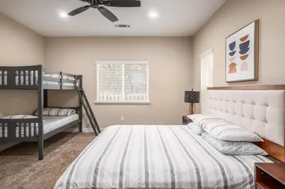 a bedroom with two bunk beds and a ceiling fan at The Oakhurst Oasis - Family & Fun Edition in Oakhurst