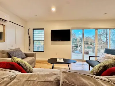 a living room with two couches and a table at Unique Container, Home 20 Acres, Modern Stay in Placerville