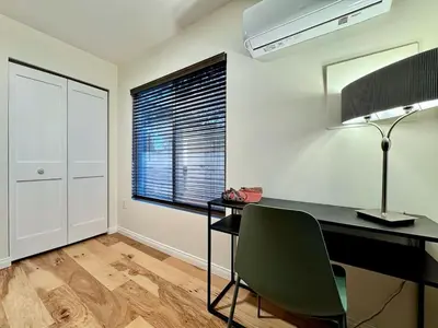 a room with a desk with a lamp and a window at Unique Container, Home 20 Acres, Modern Stay in Placerville