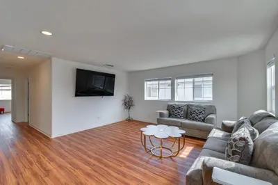 a living room with a couch and a table at 7 Mi to Lake Yosemite Family Home with Fenced Yard in Merced