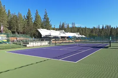a tennis court with a tennis racket on it at Scarlet Hollow Cabin at Tahoe Donner by Tahoe Getaways - 3BR w HOA Amenities in Truckee