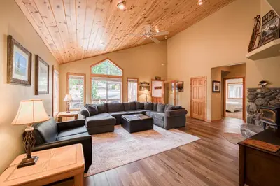 a living room with a couch and a fireplace at Scarlet Hollow Cabin at Tahoe Donner by Tahoe Getaways - 3BR w HOA Amenities in Truckee