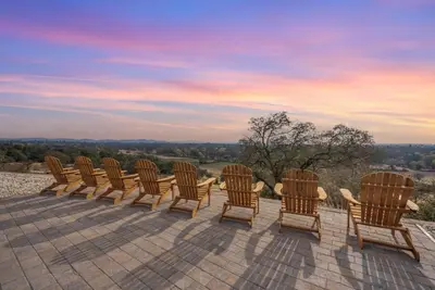 a row of chairs sitting on top of a patio at Ranch Stay-A 240 acre Working Ranch in Granite Bay