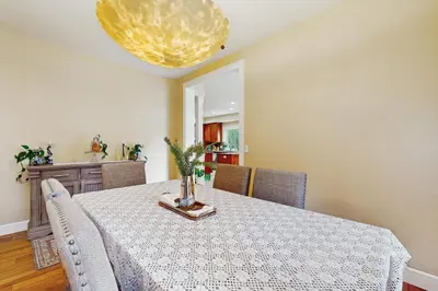 a dining room with a table and a yellow light at Games, Covered Deck Family Home 28 Mi to Yosemite in Groveland