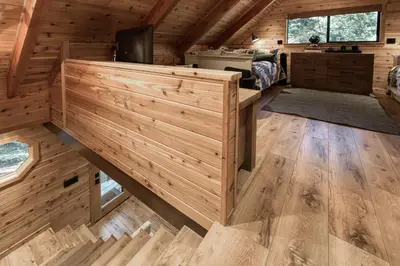 an interior view of a log cabin with wooden walls and floors at Songbird Cabin at Chambers by Tahoe Getaways - Pet-Friendly 2 BR with HOA Access in Homewood