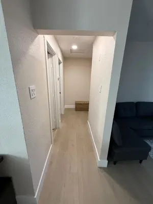 a living room with a blue couch and a hallway at 2 bed 1 bath special woodlake B in Sacramento
