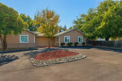 a house with a tree in the middle of a driveway at 2 bed 1 bath special woodlake duplex A in Sacramento