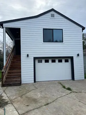 a white garage with a door and a window at The studio for all your needs in Sacramento