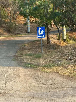 a blue sign on the side of a road at Home away from Home - 6 miles from the SNP in Three Rivers
