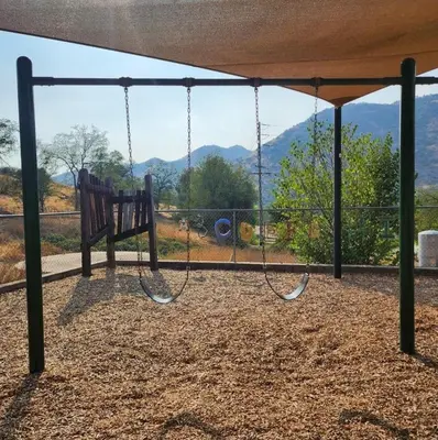a swing set with a view of the mountains at Home away from Home - 6 miles from the SNP in Three Rivers