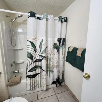 a bathroom with a shower curtain with a bird at The Getaway -6 miles from SNP in Three Rivers