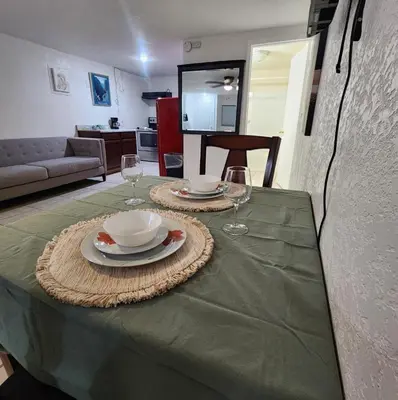 a table with two plates and glasses on top of it at The Getaway -6 miles from SNP in Three Rivers