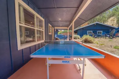 a ping pong table in the back of a house at Gateway To Sequoia River House in Three Rivers
