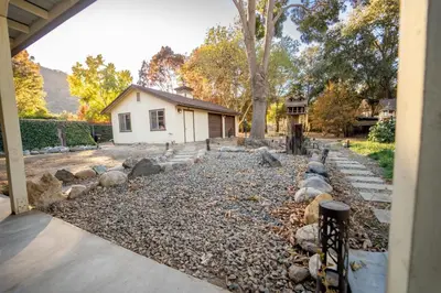 a backyard with rocks and a house at Magic Sequoia Spacious Home in Three Rivers