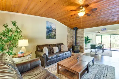 a living room with a couch and a table at Game Room and Bar Wooded Pine Mountain Lake Retreat in Groveland