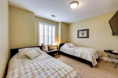 a bedroom with two beds and a window at Golf, Hike, Explore Apt 9 Mi to Dtwn Fresno! in Fresno
