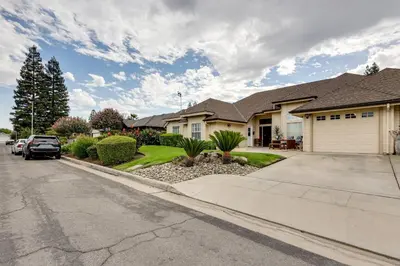a house with a car parked in the driveway at Golf, Hike, Explore Apt 9 Mi to Dtwn Fresno! in Fresno