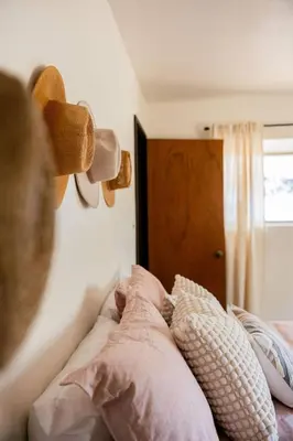 a person is sitting on a bed with pillows at Tallwood Cabin A Treetop Mountain Retreat in Shaver Lake