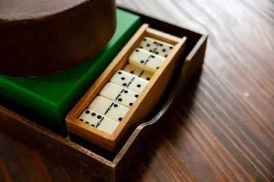a small wooden box with a dominoes at Tallwood Cabin A Treetop Mountain Retreat in Shaver Lake