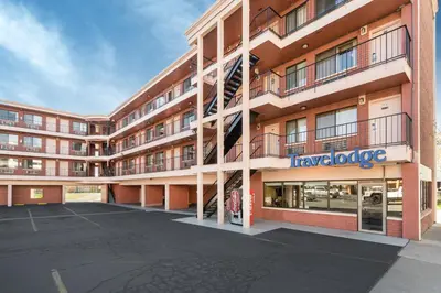 a large apartment building with a parking lot at Travelodge by Wyndham Reno in Reno