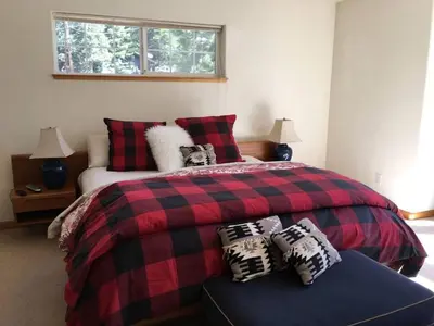 a bedroom with a red and black bed with pillows at Large 3 Bedrooms Outdoor Seating in Tahoe Vista