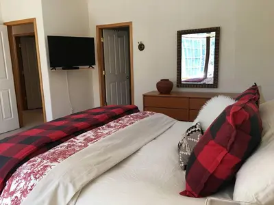 a bedroom with a bed with a red and black blanket at Large 3 Bedrooms Outdoor Seating in Tahoe Vista