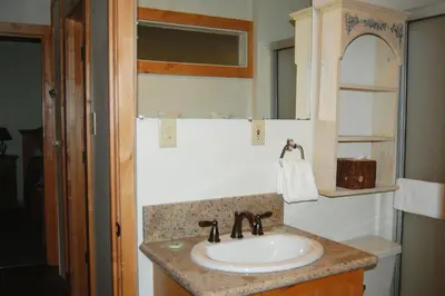 a bathroom with a sink and a mirror at Ox Yoke in Wawona
