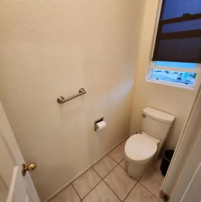a bathroom with a toilet and a window at The Gathering Spot-6 miles from Sequoia Nlt'l Park in Three Rivers