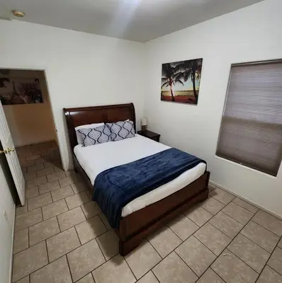 a bedroom with a bed with a blue blanket at The Gathering Spot-6 miles from Sequoia Nlt'l Park in Three Rivers