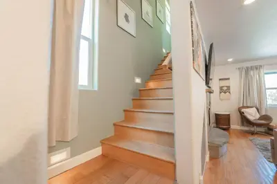 a staircase in a home with wooden floors at Riverside Retreat in Three Rivers - Natures Paradise in Three Rivers