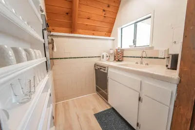 a small kitchen with a sink and a counter at Sequoia Vintage A-frame River Retreat in Three Rivers