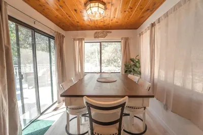 a dining room with a wooden table and chairs at Sequoia Vintage A-frame River Retreat in Three Rivers