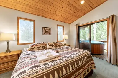 a bedroom with a bed and a large window at 589 Danube Drive condo in South Lake Tahoe
