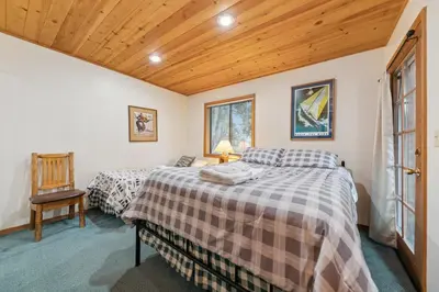 a bedroom with two beds and a wooden ceiling at 587 Danube Drive condo in South Lake Tahoe