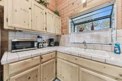 a kitchen with a sink and a microwave at 587 Danube Drive condo in South Lake Tahoe