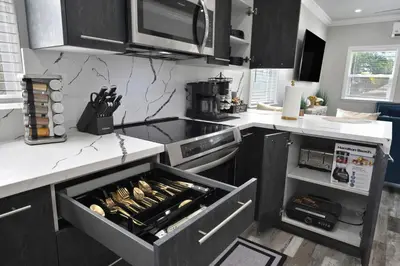a kitchen with an open drawer with food on it at Walk to UC Davis Medical Center! Duplex with Patio in Sacramento