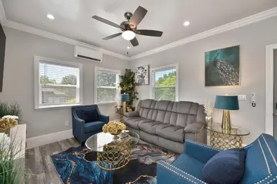 a living room with a couch and a ceiling fan at Walk to UC Davis Medical Center! Duplex with Patio in Sacramento