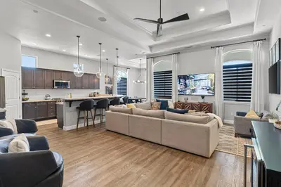 a kitchen and living room with a couch and a table at The Executive Retreat at Westberry in Madera