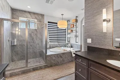 a bathroom with a shower and a sink at The Executive Retreat at Westberry in Madera