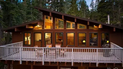 a home with a wrap around porch and glass windows at Sleeps 20 2 Homes Near Ski Resort Beach Lake Access Pool Homewood in Tahoma