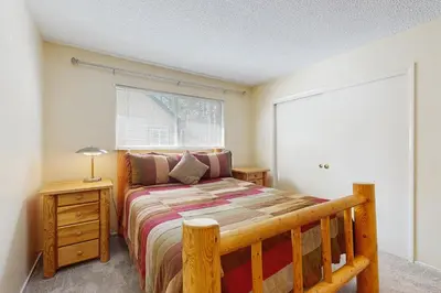 a bedroom with a wooden bed and a window at Glenwood Getaway in South Lake Tahoe