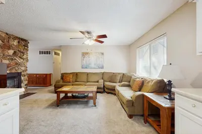 a living room with a couch and a ceiling fan at Glenwood Getaway in South Lake Tahoe