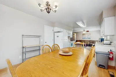 a kitchen and dining room with a wooden table and chairs at Glenwood Getaway in South Lake Tahoe