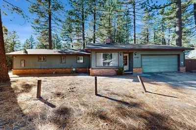 a house with a garage in a yard at Glenwood Getaway in South Lake Tahoe