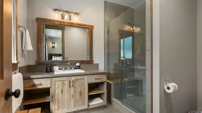 a bathroom with a sink and a shower with a mirror at South Lake Escape Indoor Pool plus Movie Theater in South Lake Tahoe