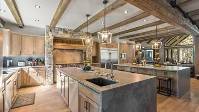 a large kitchen with wooden cabinets and a sink at South Lake Escape Indoor Pool plus Movie Theater in South Lake Tahoe