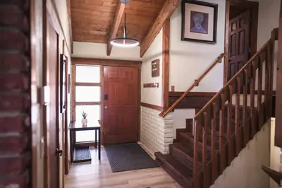 a hallway with a wooden door and stairs with a table at Pine Ridge Retreat in Stateline
