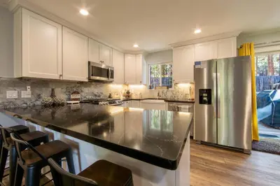 a large kitchen with a stainless steel refrigerator at Private Woods - Cottage for 4 in South Lake Tahoe