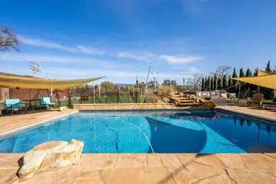 a large swimming pool with blue water at Grand Wine Country 6BR Retreat Hot Tub & Views in San Martin