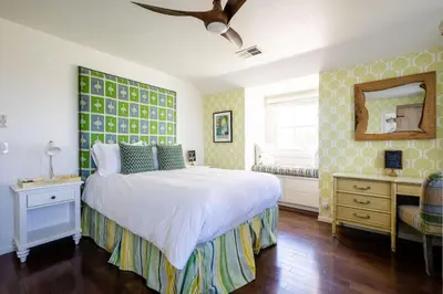 a bedroom with a bed and a dresser and a mirror at Grand Wine Country 6BR Retreat Hot Tub & Views in San Martin